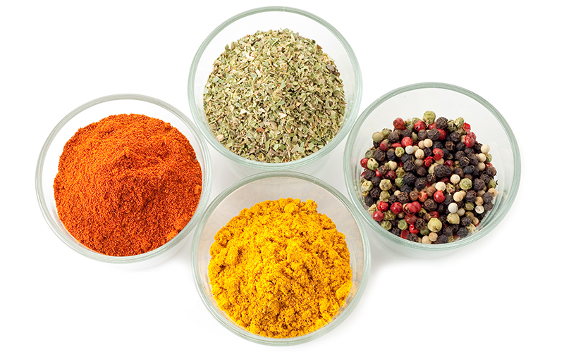 Small selection of herbs and spices ingredients in glass jars