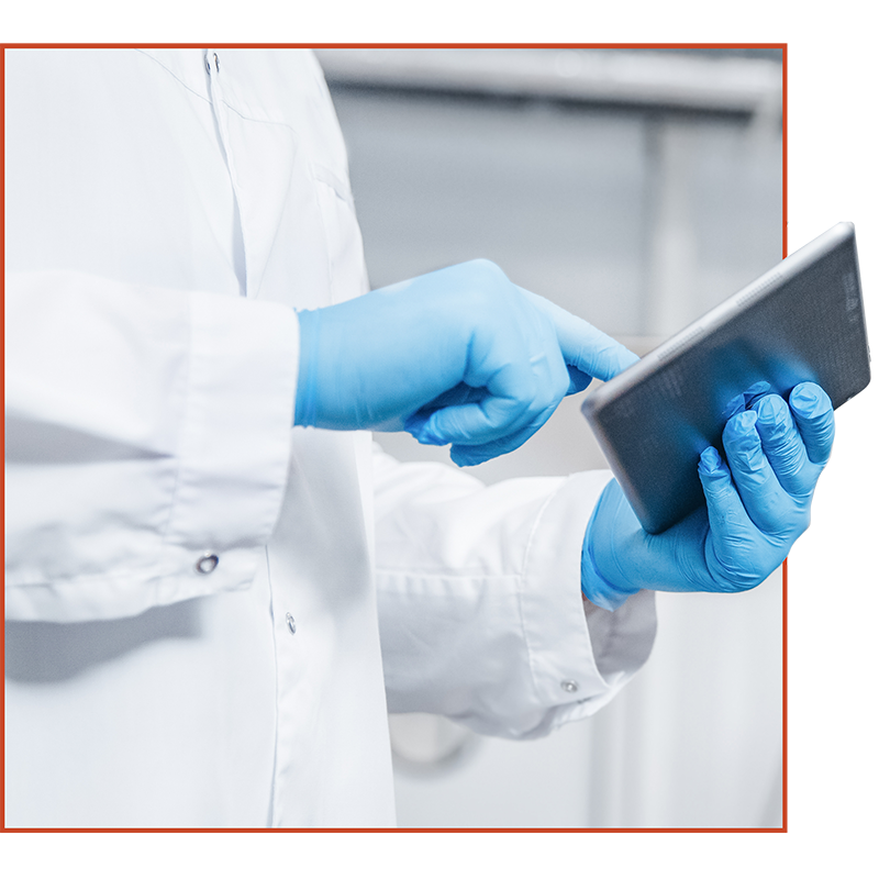 Factory worker using electronic tablet in factory