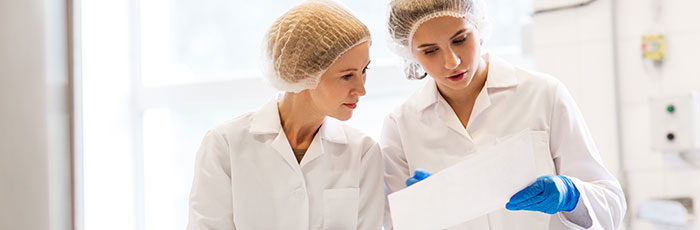 Factory workers with piece of paper