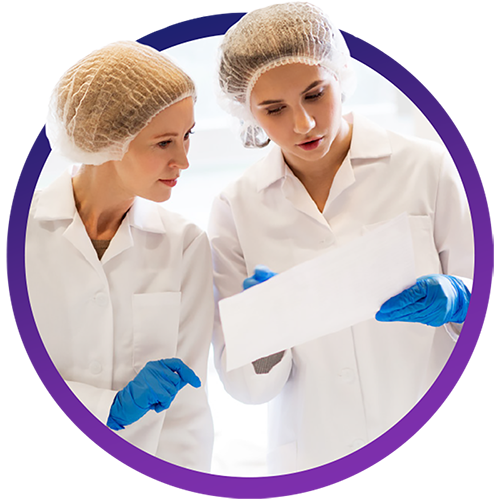 Factory workers looking at piece of paper
