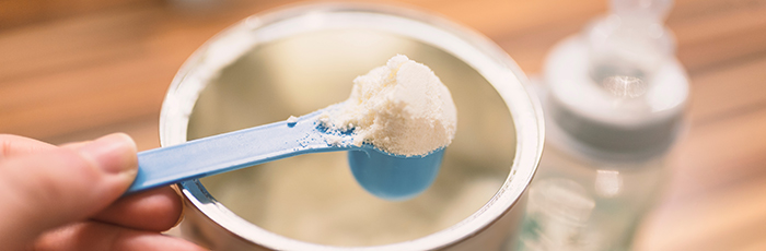 Baby formula being scooped out of tin