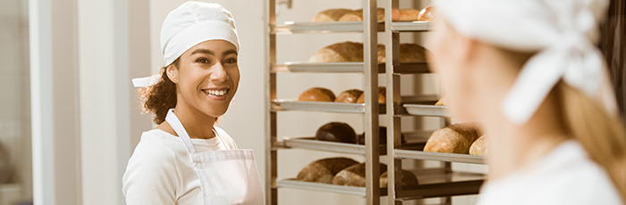 Baker smiling with croissants