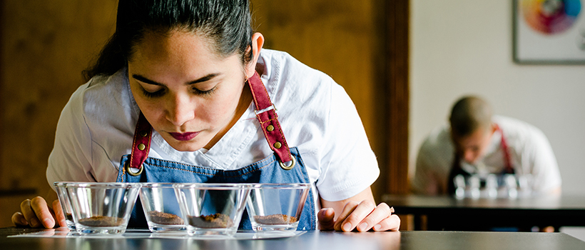 Woman performing sensory testing on coffee