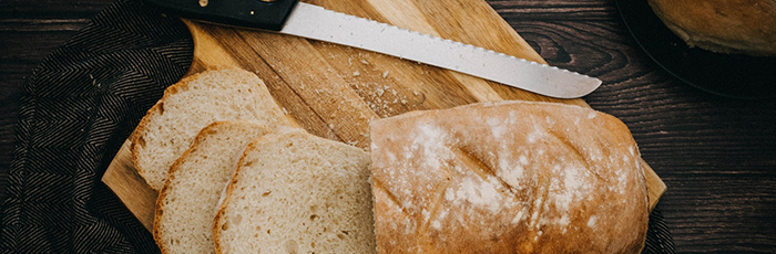 Sliced loaf of bread on chopping board