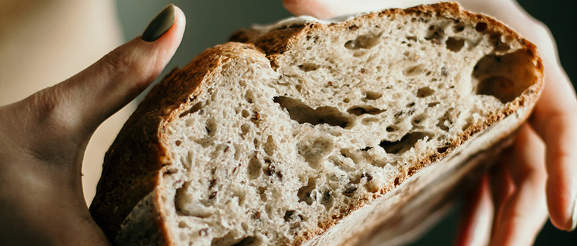 Woman squeezing loaf of bread