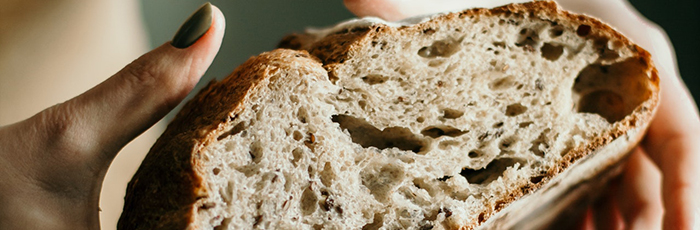 Woman squeezing loaf of bread