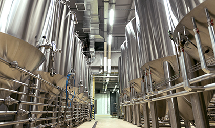 Large stainless steel brewing tanks in brewery