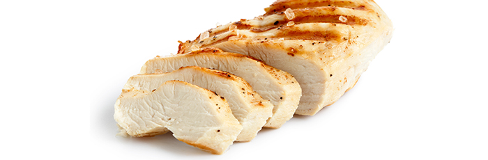 Grilled sliced chicken breast on white background