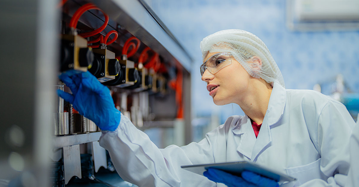Factory worker performing factory audit with electronic tablet