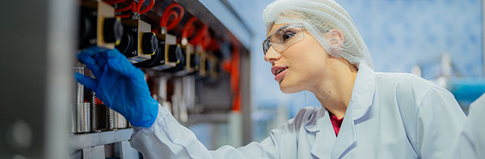 Factory worker performing factory audit with electronic tablet