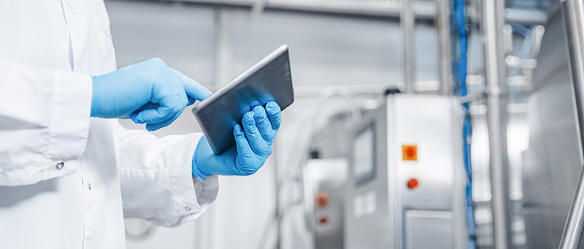 Factory worker holding electronic tablet in factory