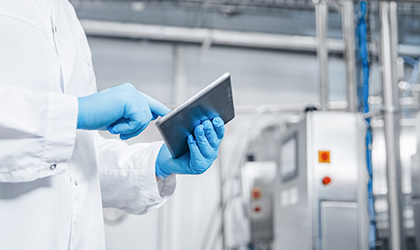 Factory worker holding electronic tablet in factory
