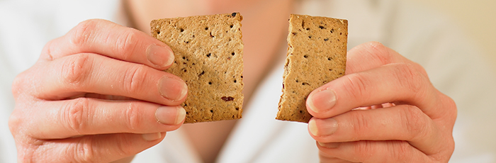 Food scientist snapping biscuit in half