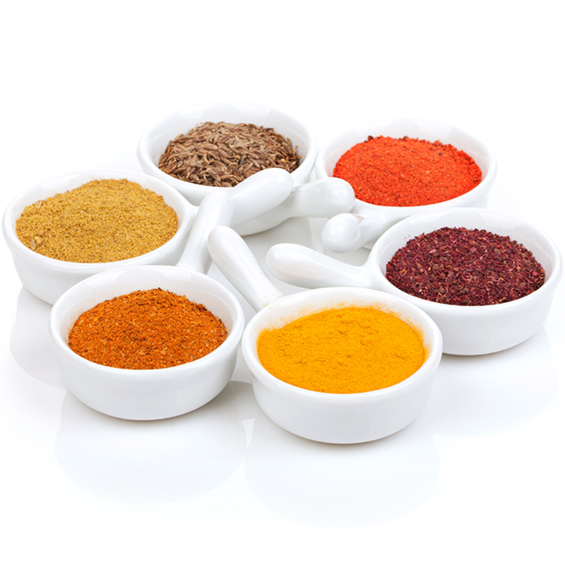 Small selection of herbs and spices ingredients in small white dishes
