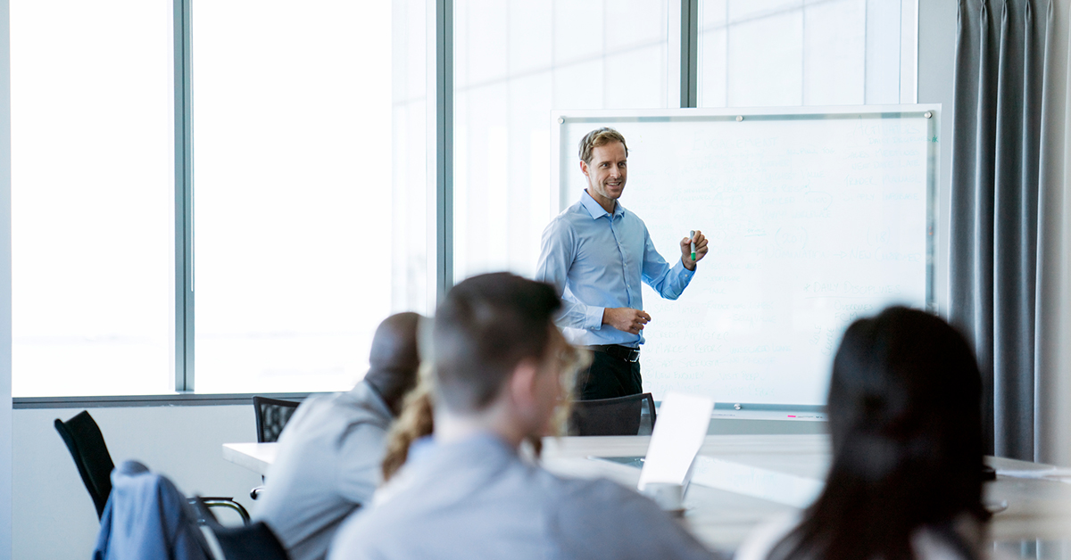 Man presenting with flip chart in front of an audience