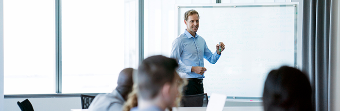 Man presenting with flip chart in front of an audience