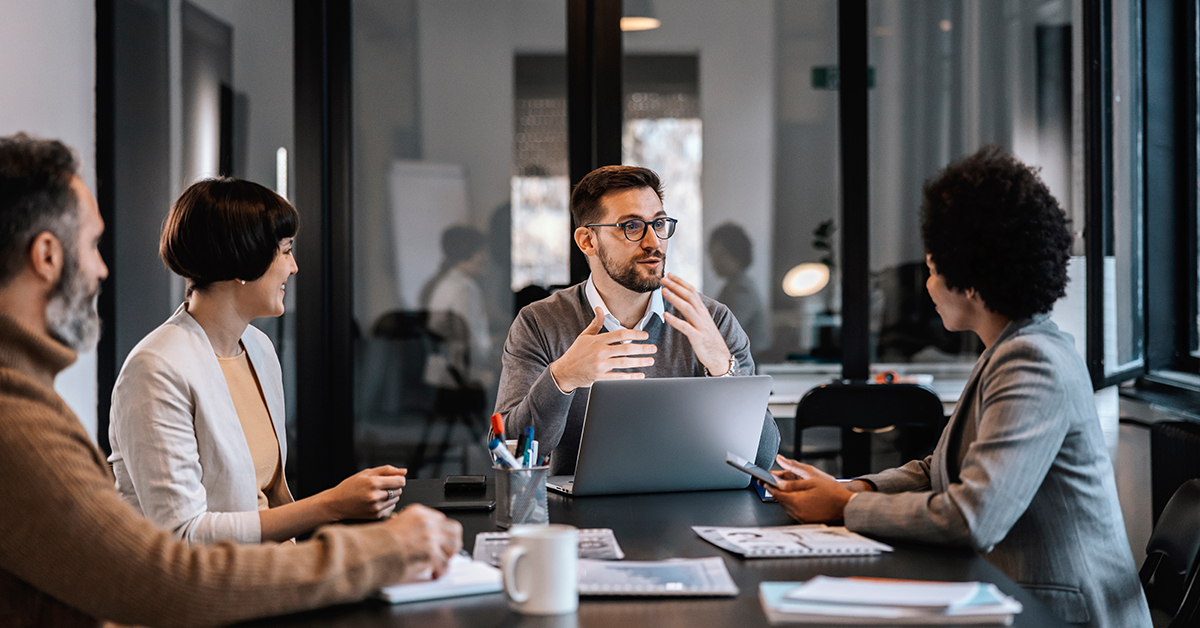 People around a table having a meeting in a meeting room