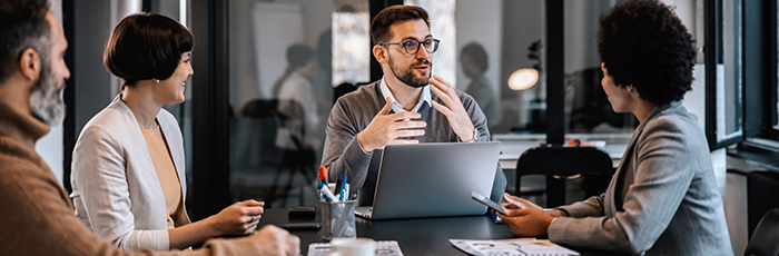 People around a table having a meeting in a meeting room