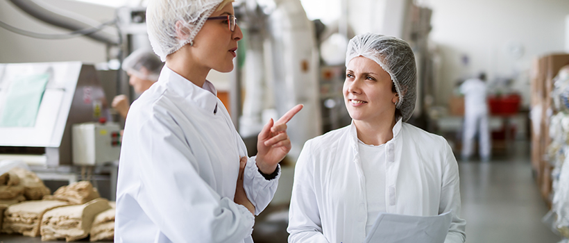 Factory workers talking in factory