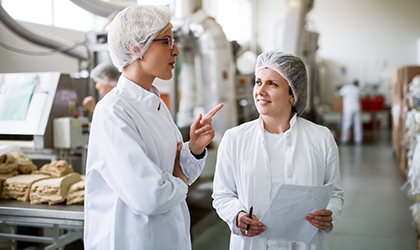 Factory workers talking in factory