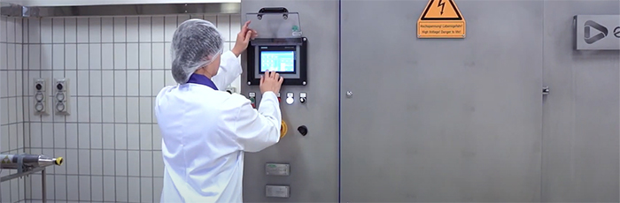 Factory worker operating pulsed electric field kit in pilot plant