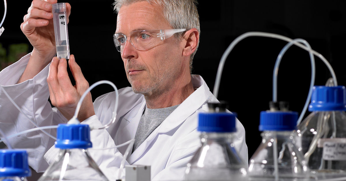 Scientist in front of chemistry equipment in laboratory