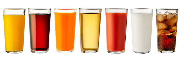 Range of soft drinks in glassware