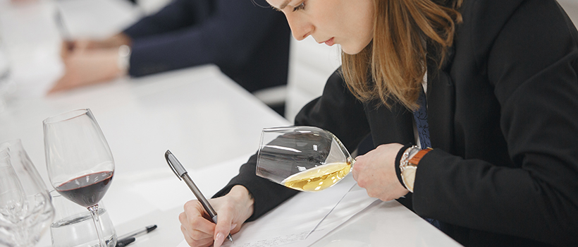 Sommelier wine tasting and taking notes