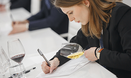 Sommelier wine tasting and taking notes