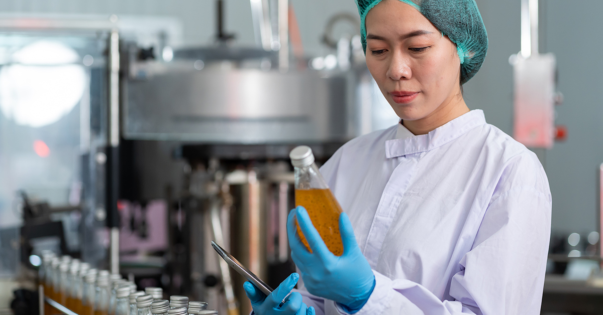 Technician checking food product during manufacturing process