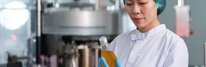 Technician checking food product during manufacturing process