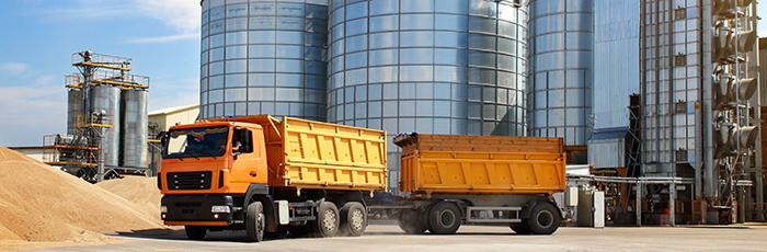 Yellow supply truck outside factory