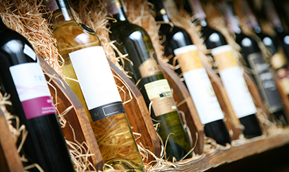 Variety of wine bottles stacked on shelf