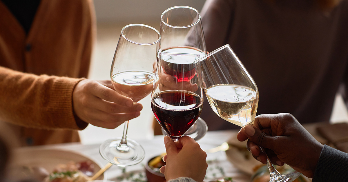 People toasting with different wine varieties in wine glasses