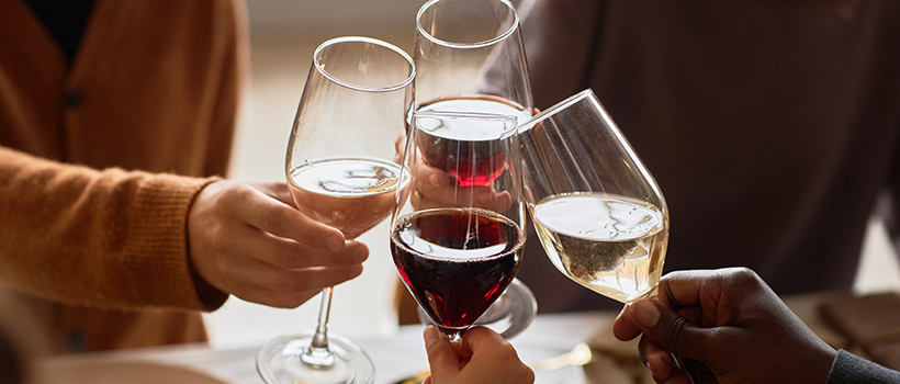 Friends toasting with wine glasses at dinner