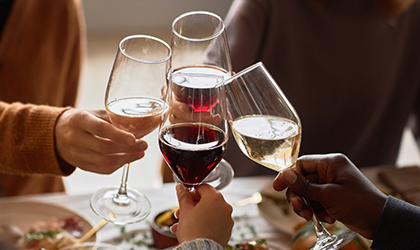 Friends toasting with wine glasses at dinner