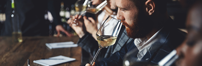 Wine tasting panel with man sipping wine