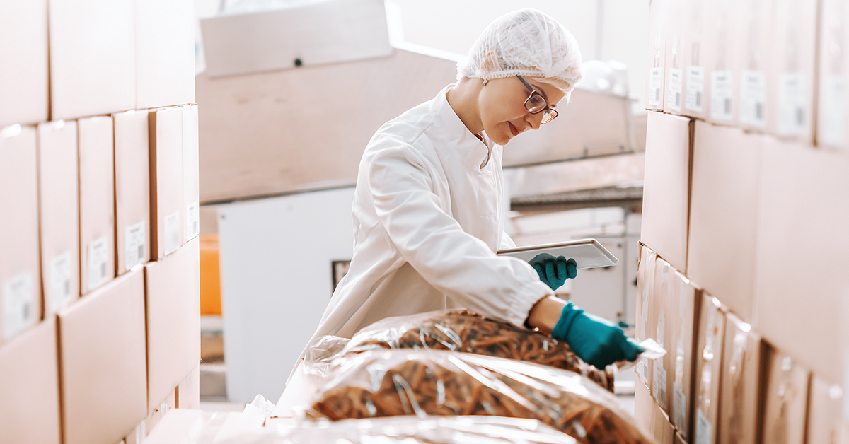 Factory working checking food ingredient delivery with electronic tablet